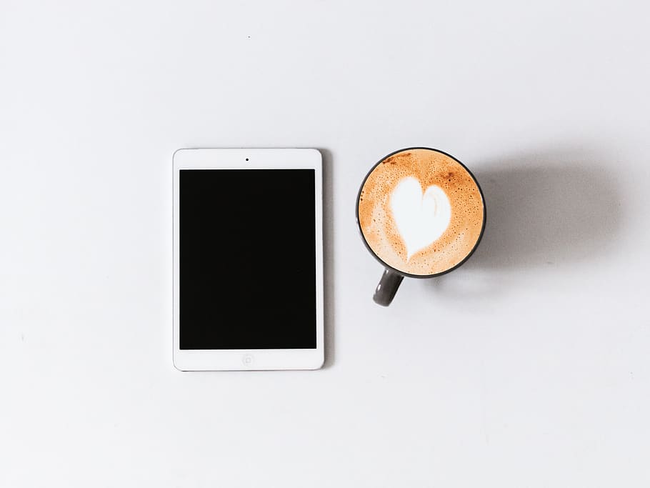 white iPad beside black ceramic mug, portable information device HD wallpaper