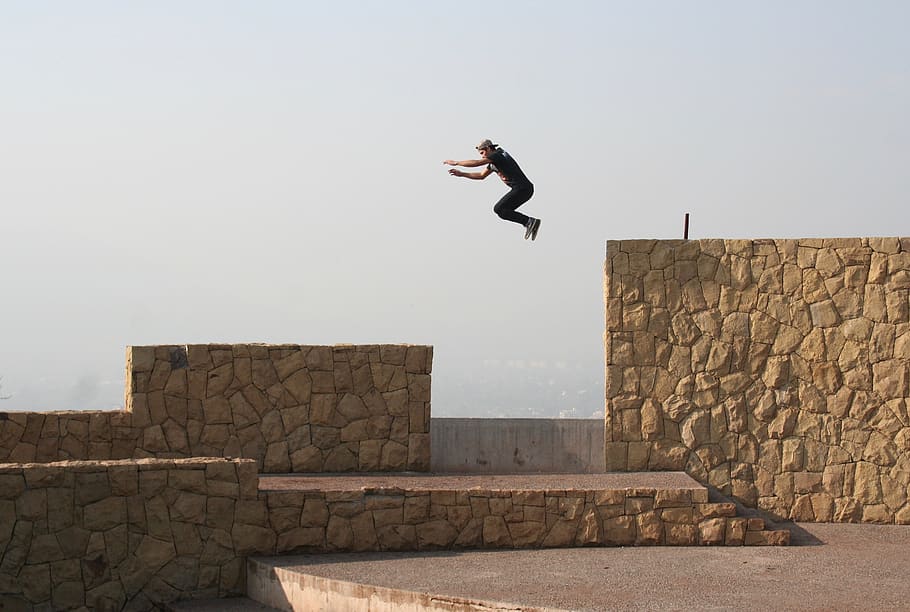 Person Jumping on Beige Concrete Wall, action, air, daylight, HD wallpaper
