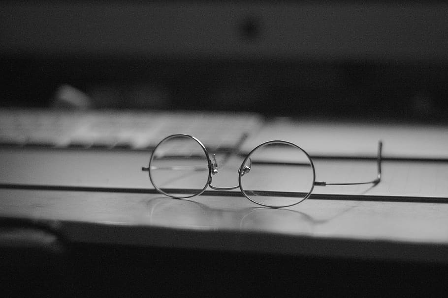 gray eyeglasses on top table, wire, keyboard, apple, dark, desk HD wallpaper