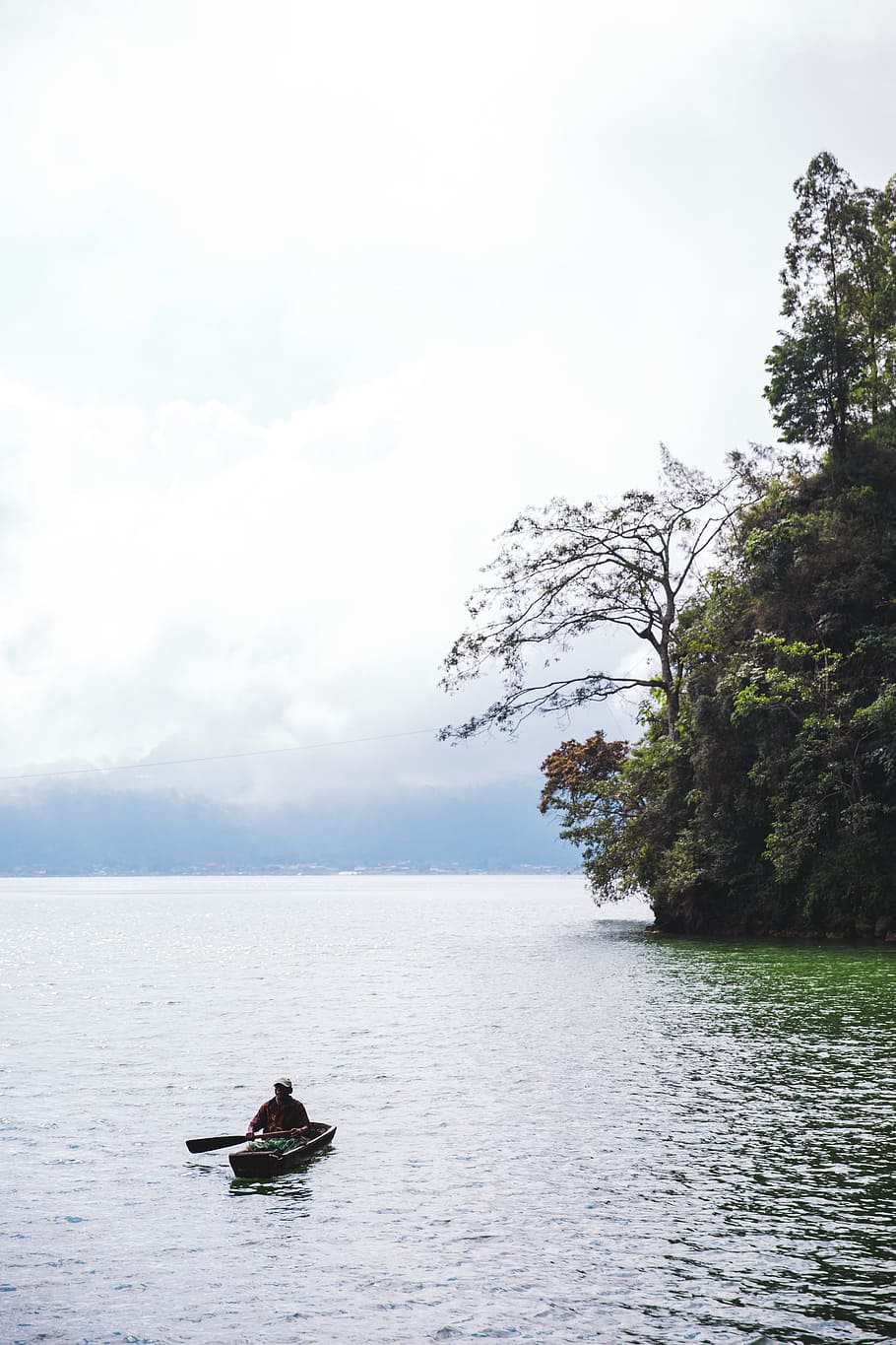 A man in a canoe in the cliffside lake, fishing, floating, green, HD wallpaper
