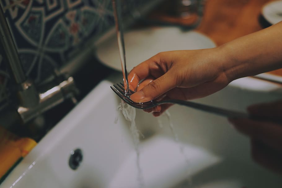 person washing fork, human hand, real people, one person, indoors HD wallpaper