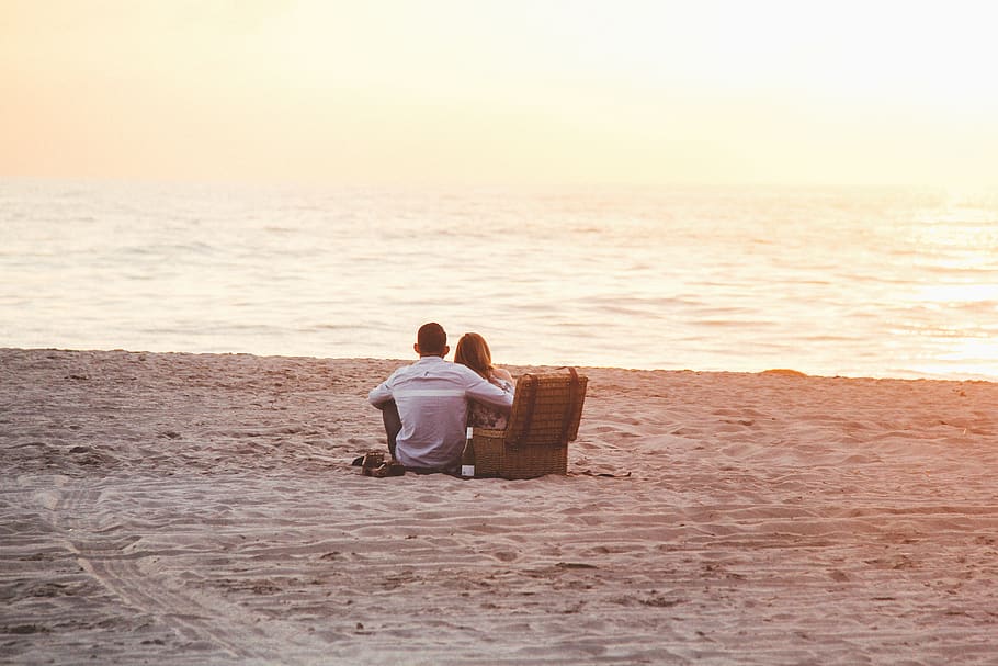 Couple at Beach Near Cooler, adults, leisure, love, ocean, people, HD wallpaper