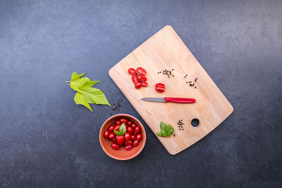 Flat Lay Photography of Rose Hips, basil, chopping board, tomatoes HD wallpaper