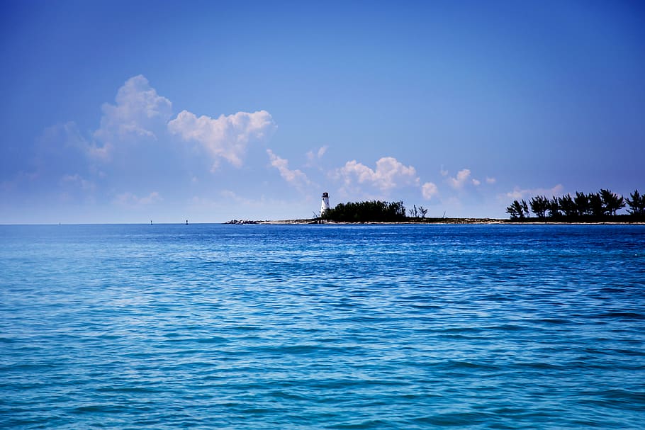lighthouse under cumulus clouds, ocean, water, sea, island, blue HD wallpaper