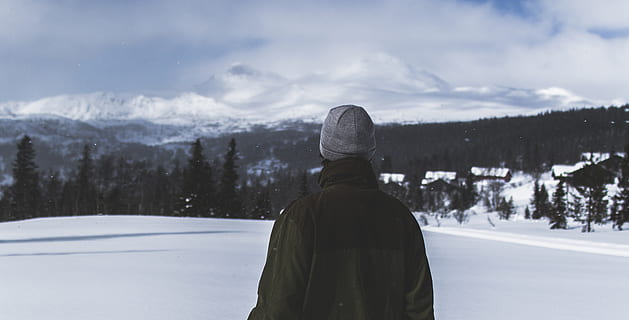 Man With Black Jacket and Grey Knit Cap Standing on White Snow Field HD wallpaper