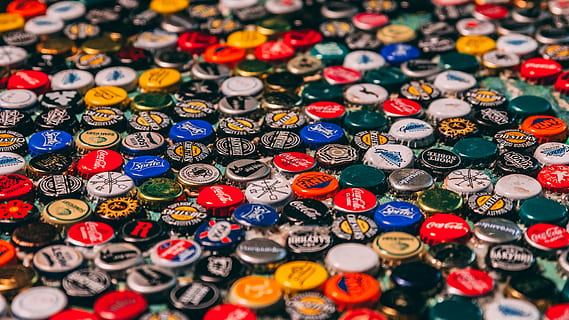 stack of assorted-color bottle caps, logo, badge, emblem, trademark HD wallpaper