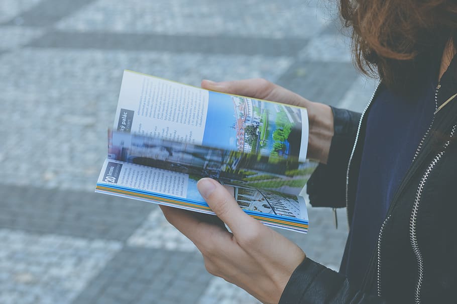 Woman in Black Zipped Jacket Hoding White and Blue Book, hands HD wallpaper