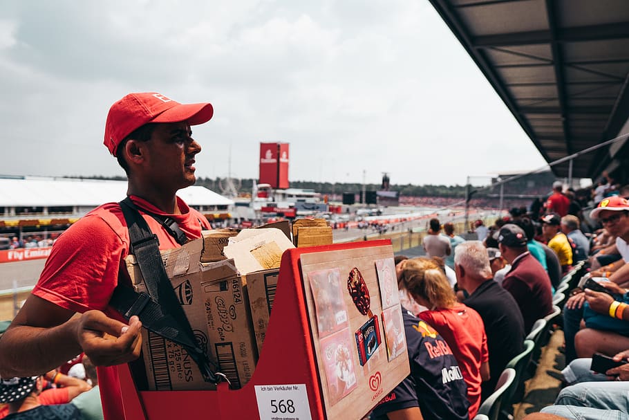 man carrying red box, red bull, mercede, ferrari, race track HD wallpaper
