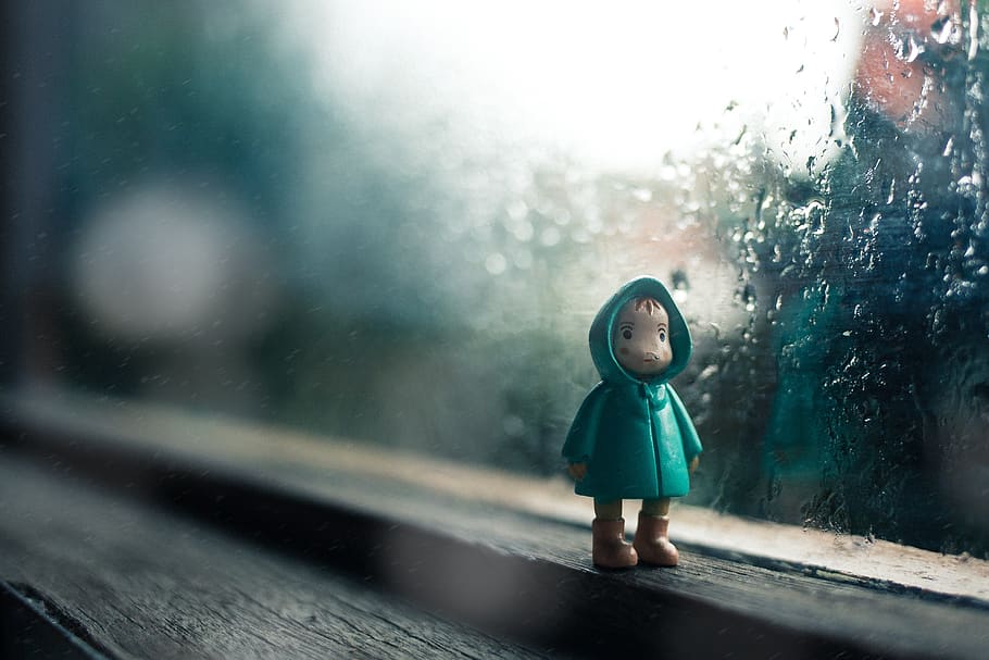 rain, drops, water, glass, toy, figure, jacket, kid, sad, window