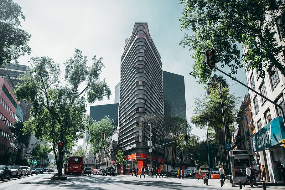 Corner view of a glass building in a tropical city on a busy day HD wallpaper