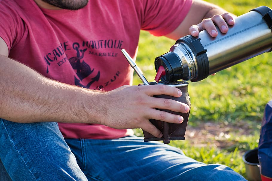 man pouring on mug, casual clothing, midsection, men, grass, holding HD wallpaper