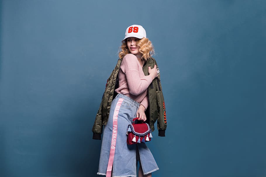 Woman in Pink Sweater and Denim Skirt, bag, blue background, cap HD wallpaper