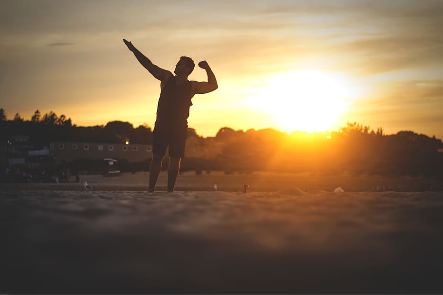 man flexing on the sand, sunrise, sunset, dawn, nature, sky, outdoors HD wallpaper