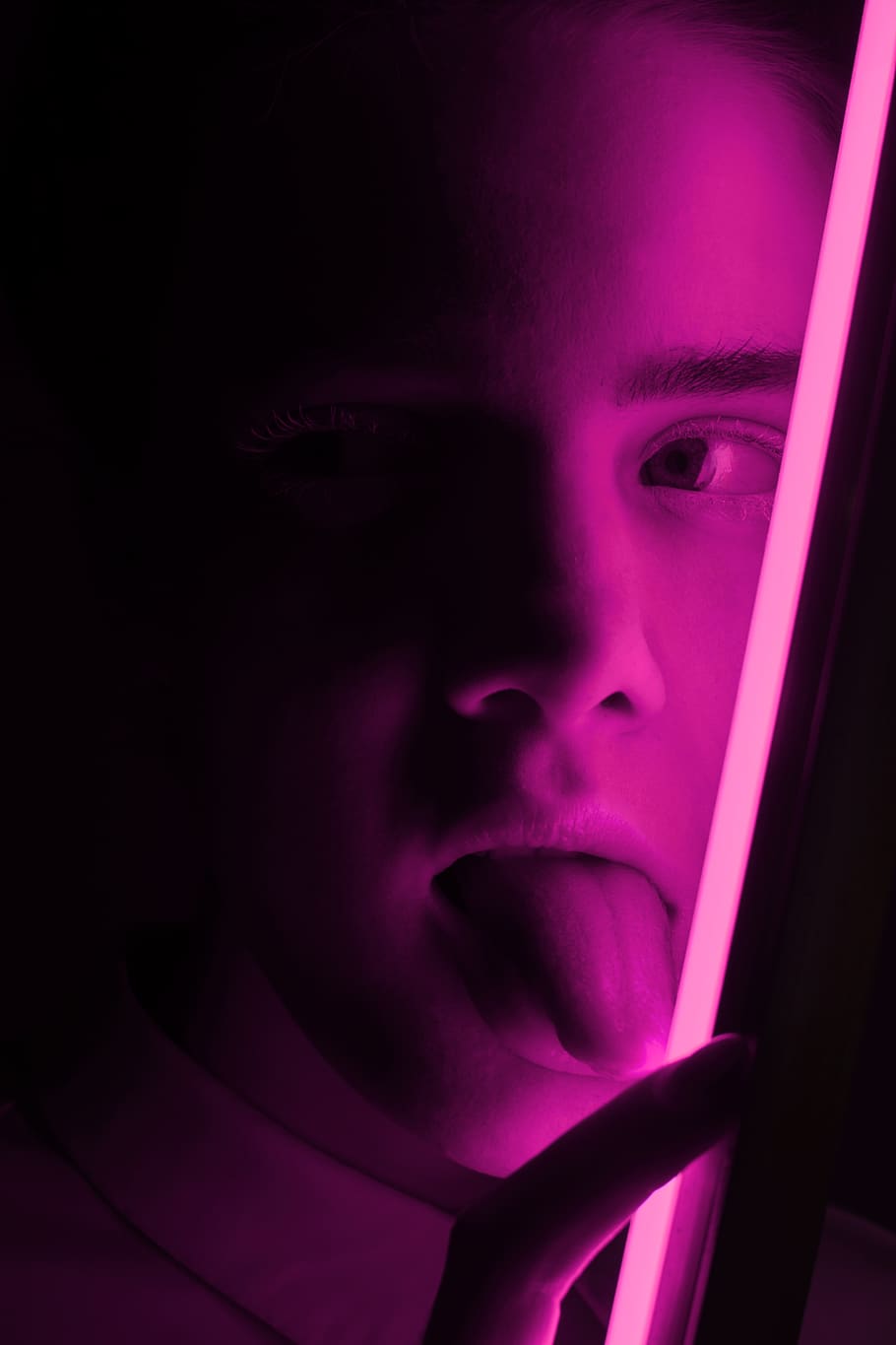 man showing tongue near pink LED light, human body part, human face, HD wallpaper