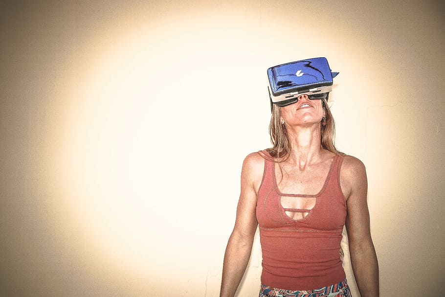 Woman in Brown Cages Sleeveless Top and Blue Virtual Reality Headset