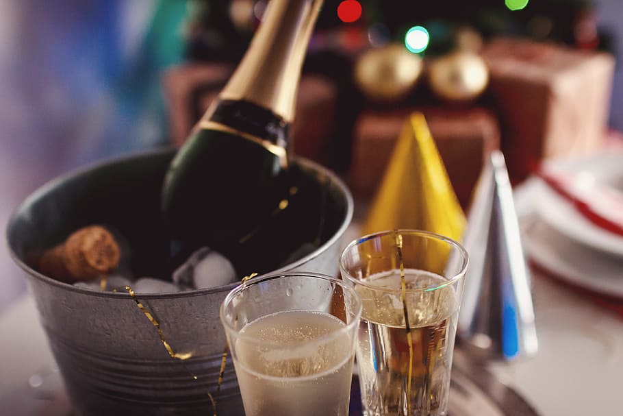 Glasses and bottle of Champagne in an ice container. Happy New Year concept. HD wallpaper