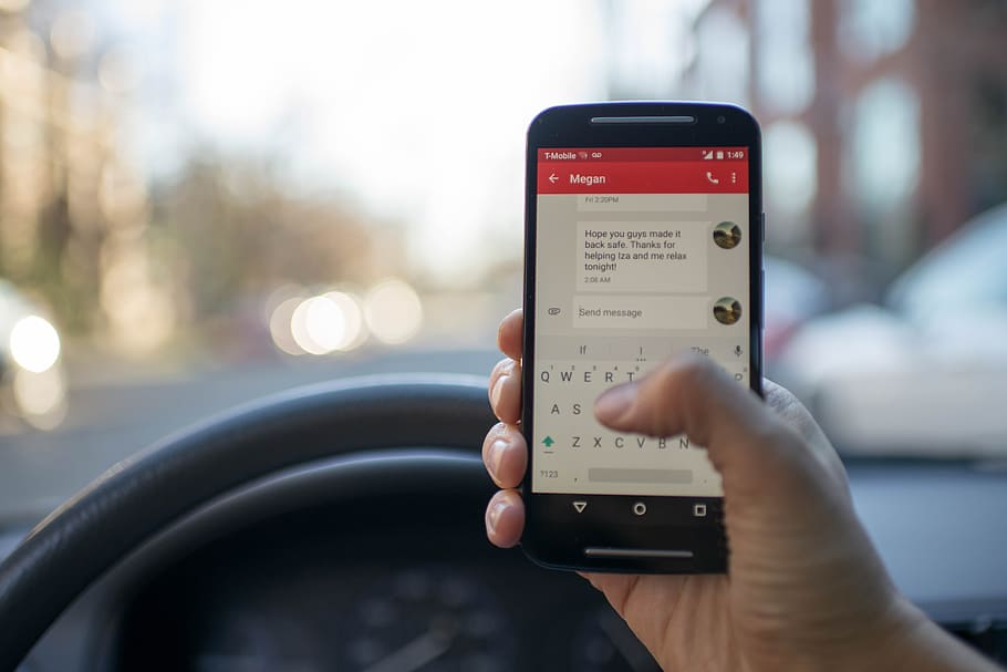 Person Sitting Inside Car With Black Android Smartphone Turned on HD wallpaper