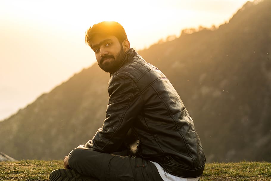 man wearing jacket sitting on grass, one person, young men, real people HD wallpaper