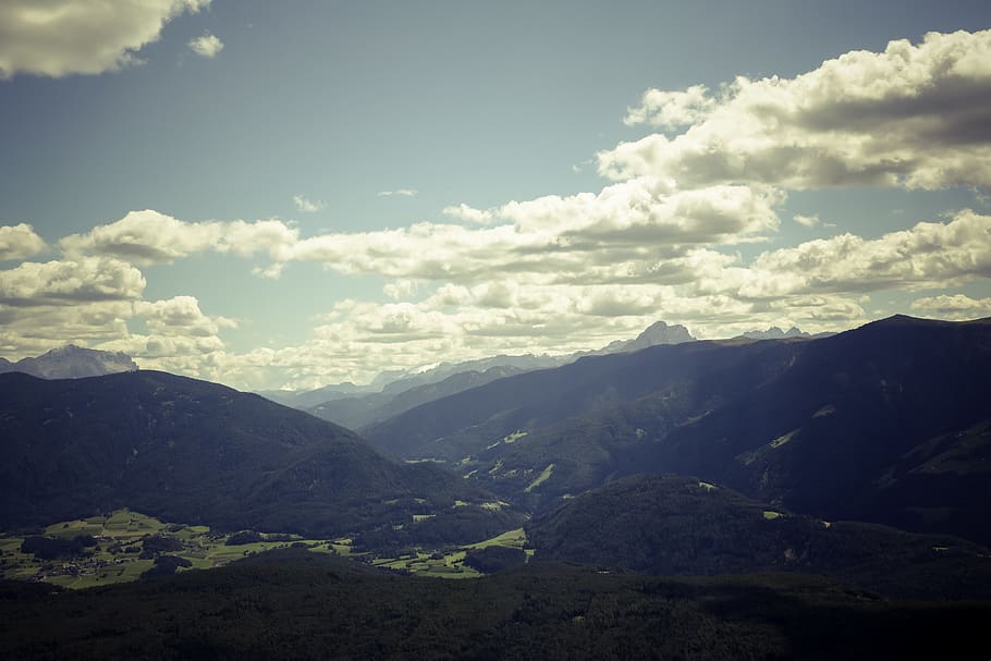 Black Mountain Range Under Gray Cloudy Sky during Daytime, daylight HD wallpaper