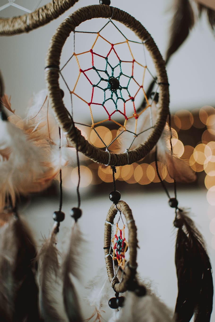 Closeup Photography of Brown Dream Catcher, beads, blurred background