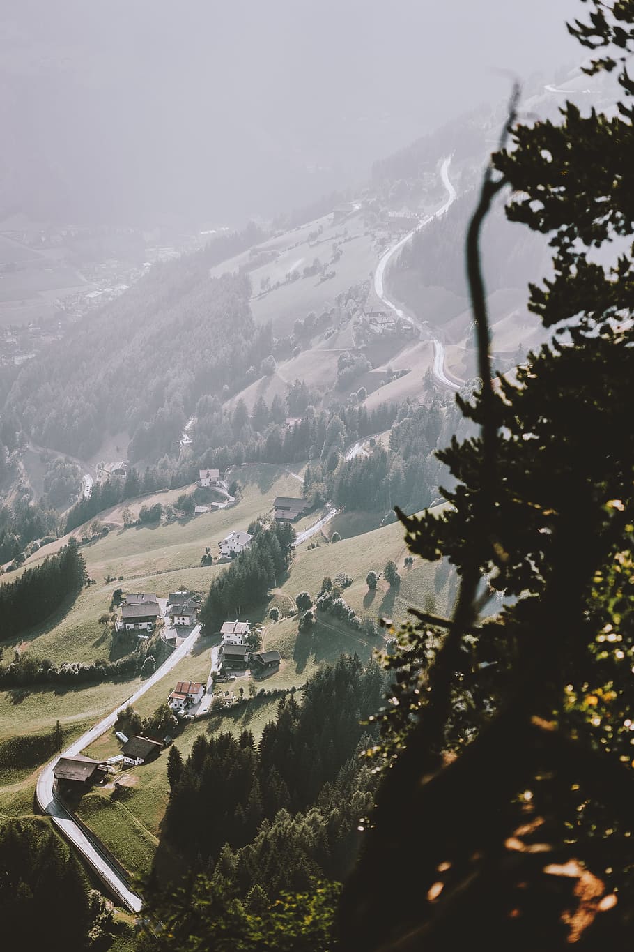 aerial photography of mountain town and road, ridge, range, haze HD wallpaper