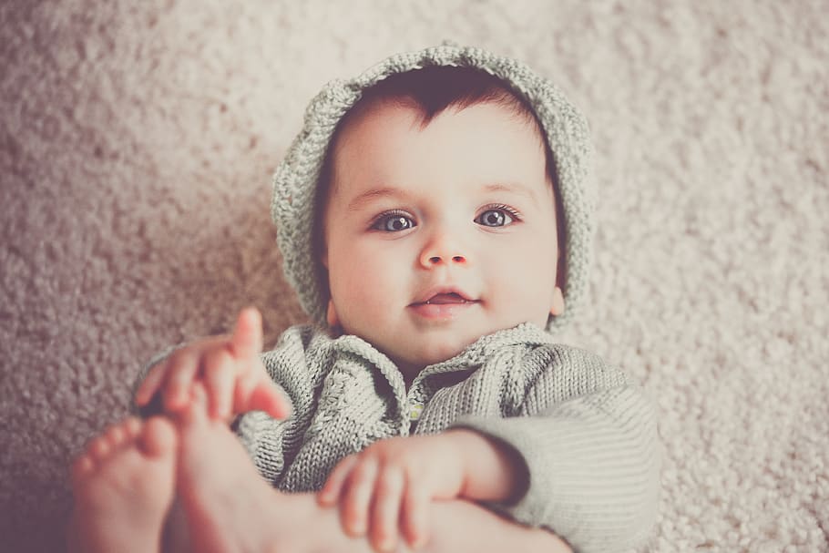 Baby on Gray Knit Hooded Clothes Lying on Carpet, adorable, beautiful