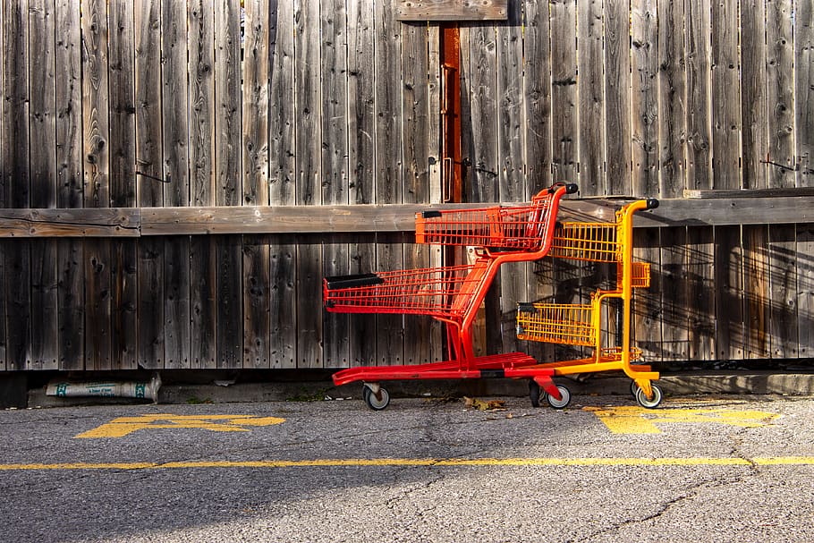 Two Red and Yellow Shopping Carts Beside Wall, daylight, fence HD wallpaper