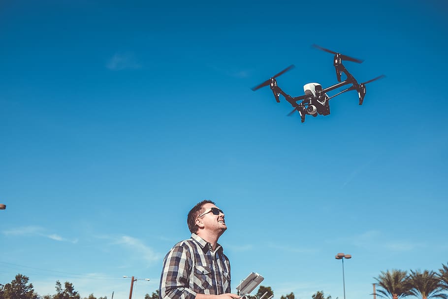 man flying drone, person, blue, human, people, drone pilot, remote control, HD wallpaper