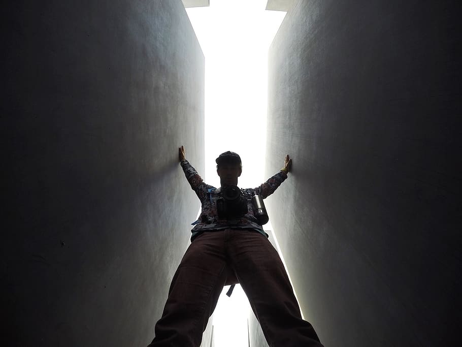 A man standing between two walls., person, lighting, clothing HD wallpaper