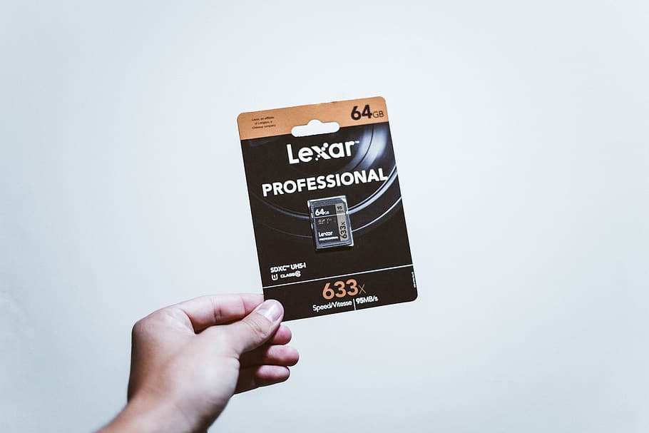 Black Lexar 64 Gb Sd Card Pack, conceptual, hand, indoors, memory card HD wallpaper