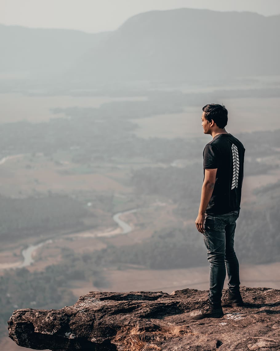 man standing on mountain edge, person, human, nature, clothing HD wallpaper
