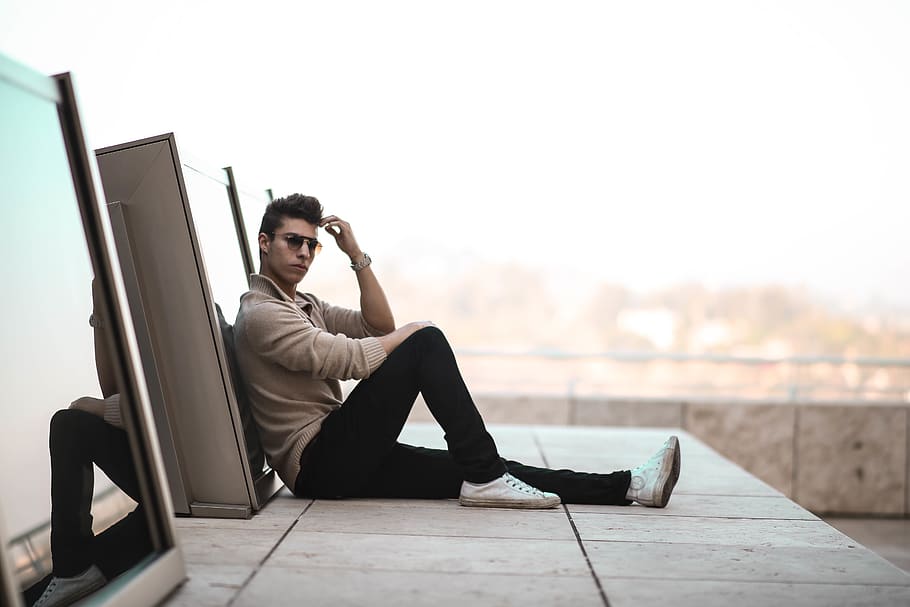 man sitting on gray concrete surface, person, human, people, shoe HD wallpaper