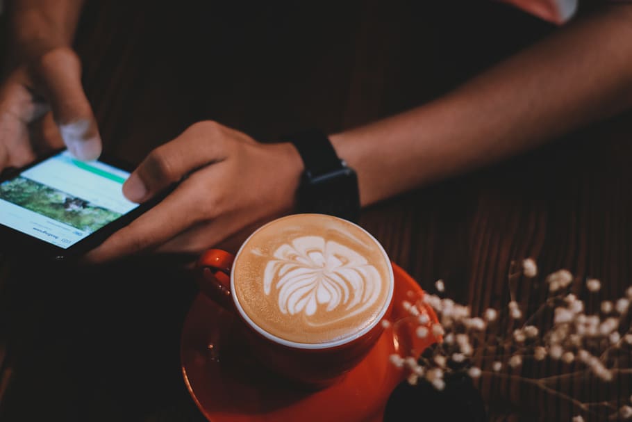 Person Holding Smartphone Beside Cup Of Coffee , beverage, caffeine HD wallpaper