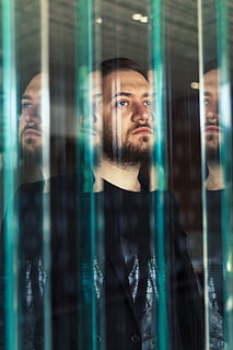 man facing glass mirror, face, human, person, door, beard, handrail HD wallpaper