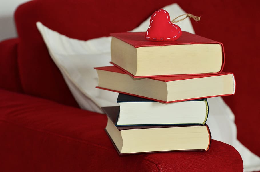 Red Heart Keychain on Top of Stacking of Books, sofa, indoors HD wallpaper