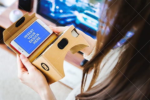 PSD Mockup. Girl uses her smartphone for Virtual Reality (VR). Cardboard. HD wallpaper