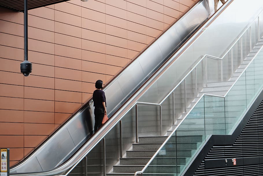 woman on an escalator going up, handrail, banister, person, human, HD wallpaper