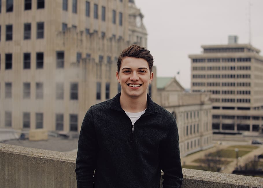 smiling man in black zip-up jacket, building exterior, architecture HD wallpaper