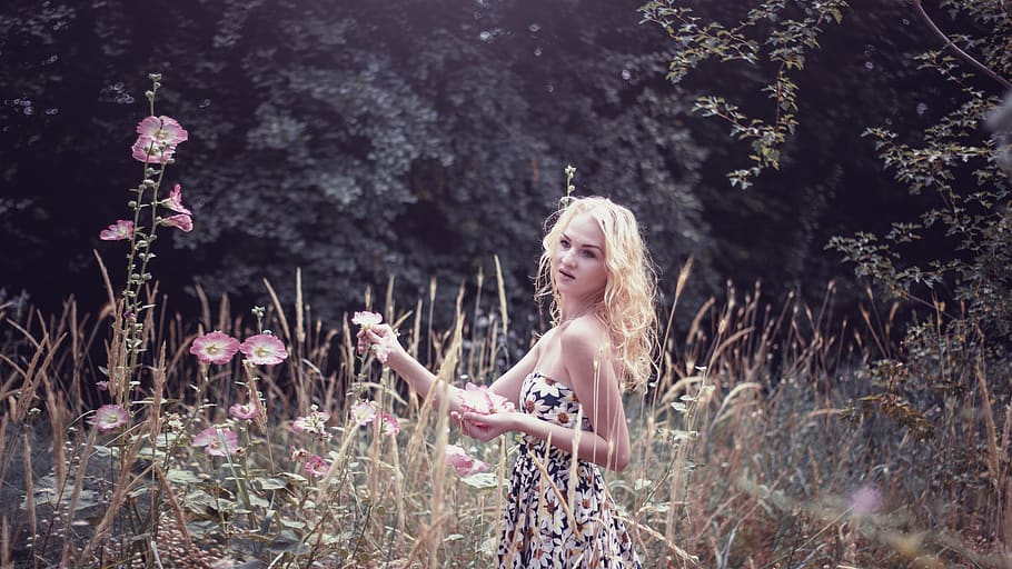 Woman in White Black and Green Floral Tube Dress Standing on Green Grass Field during Daytime HD wallpaper