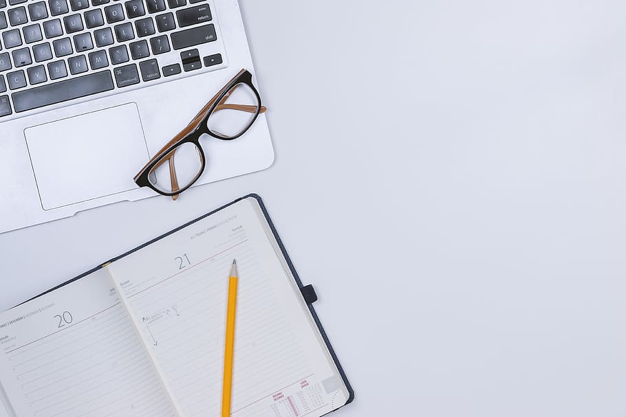 White work table with diary and laptop, computer, eyeglasses HD wallpaper