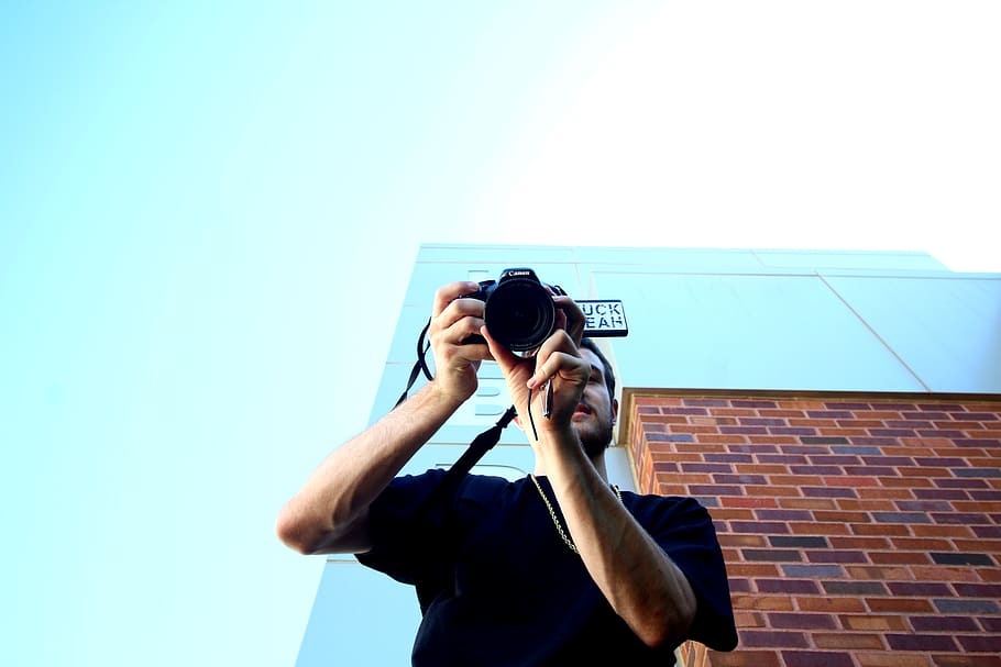 man standing and using DSLR camera, person, human, electronics HD wallpaper