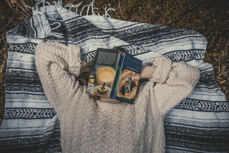 person's face covered with book, clothing, indoors, textile, high angle view HD wallpaper