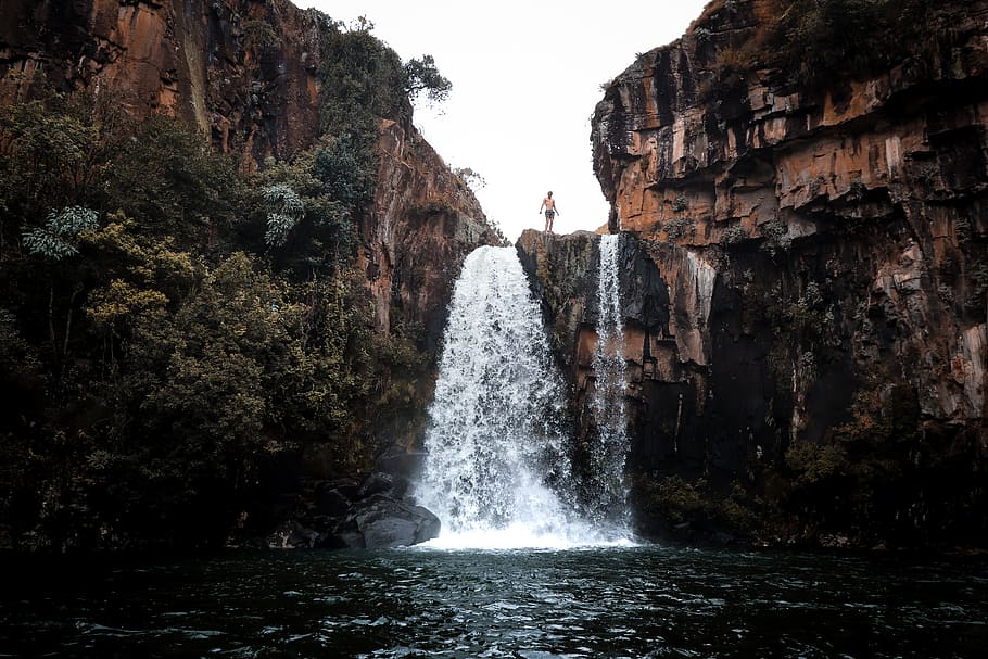 man standing on waterfalls top, motion, scenics - nature, long exposure HD wallpaper