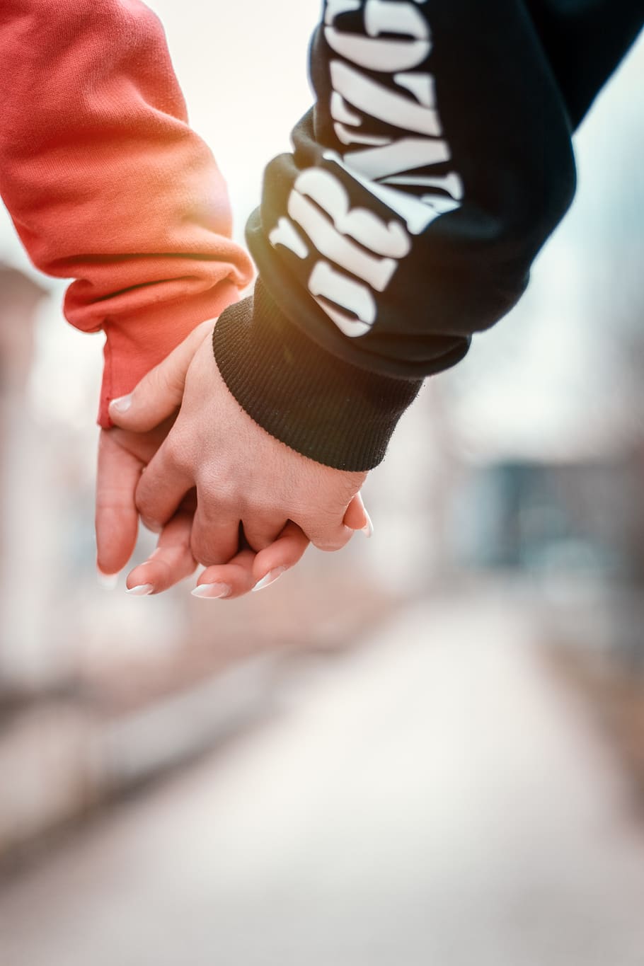 two person holding hands in selective focus photography, human