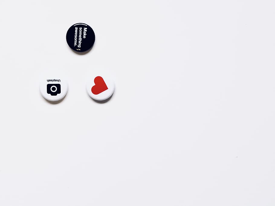 three white and black button pins on white surface, badge, table HD wallpaper