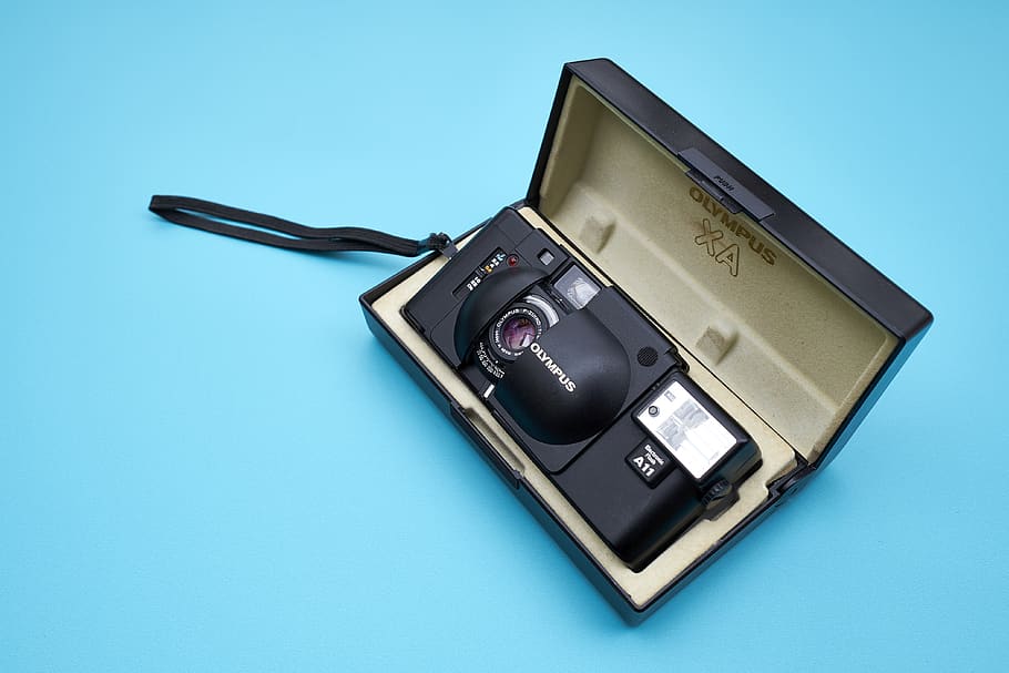 black camera with case, colored background, studio shot, blue HD wallpaper