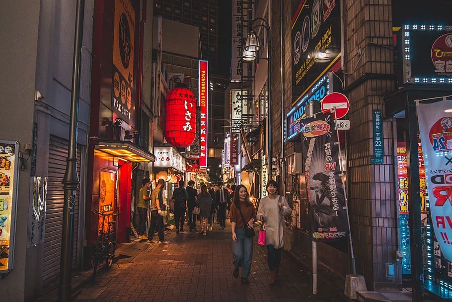 people walking on pathway near buildings at night, street, road