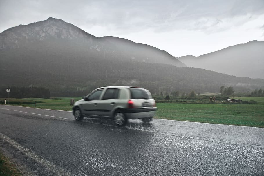 Blur View Of Car on road in the rain with mountain, clouds, drive HD wallpaper