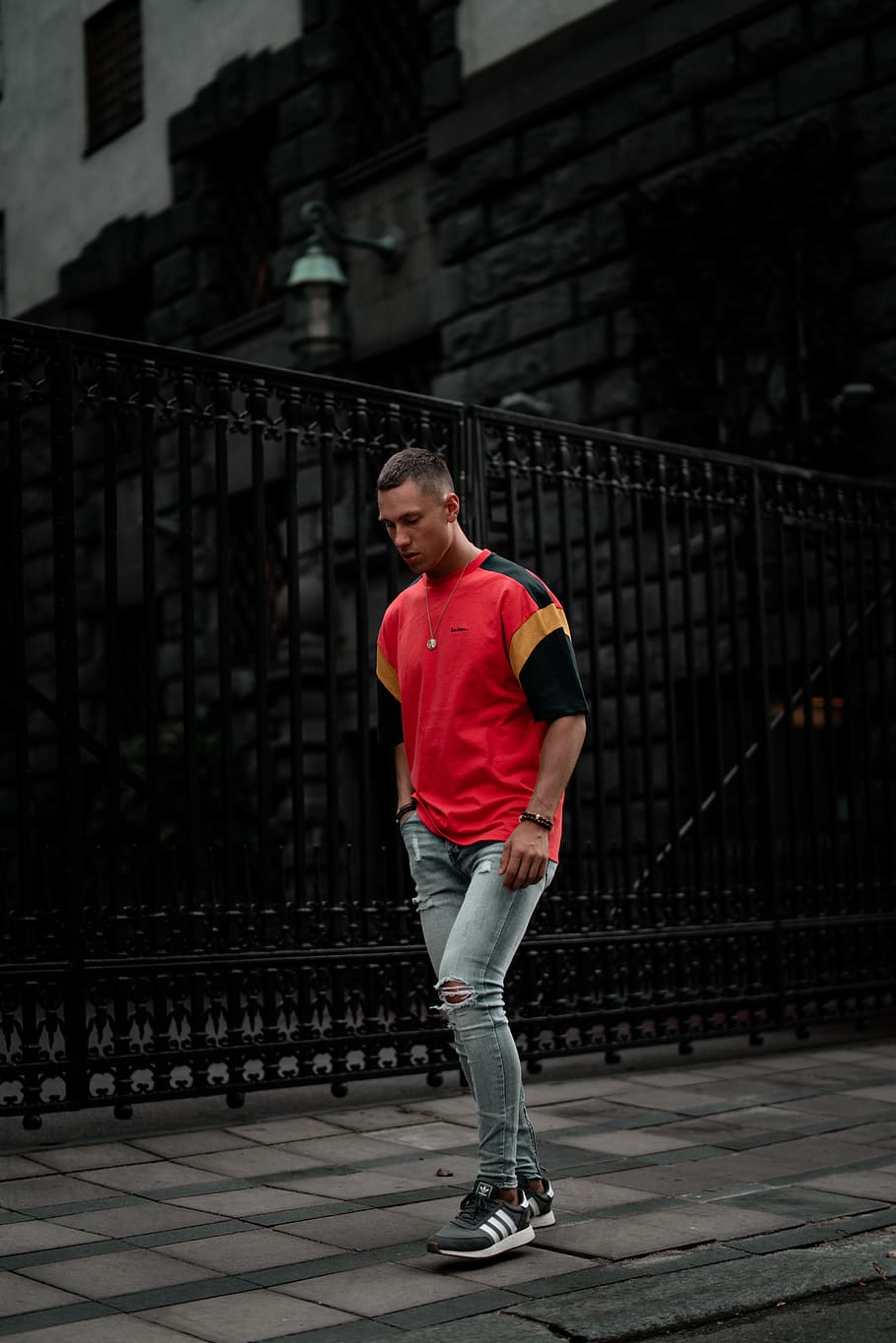 standing man wearing red and black t-shirt, boy, denim, fence HD wallpaper