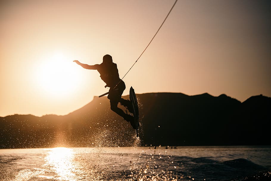 person wake boarding on body of water, sunset, sky, one person, HD wallpaper